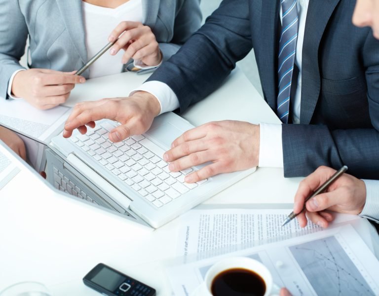 Group of business people working with laptop at meeting